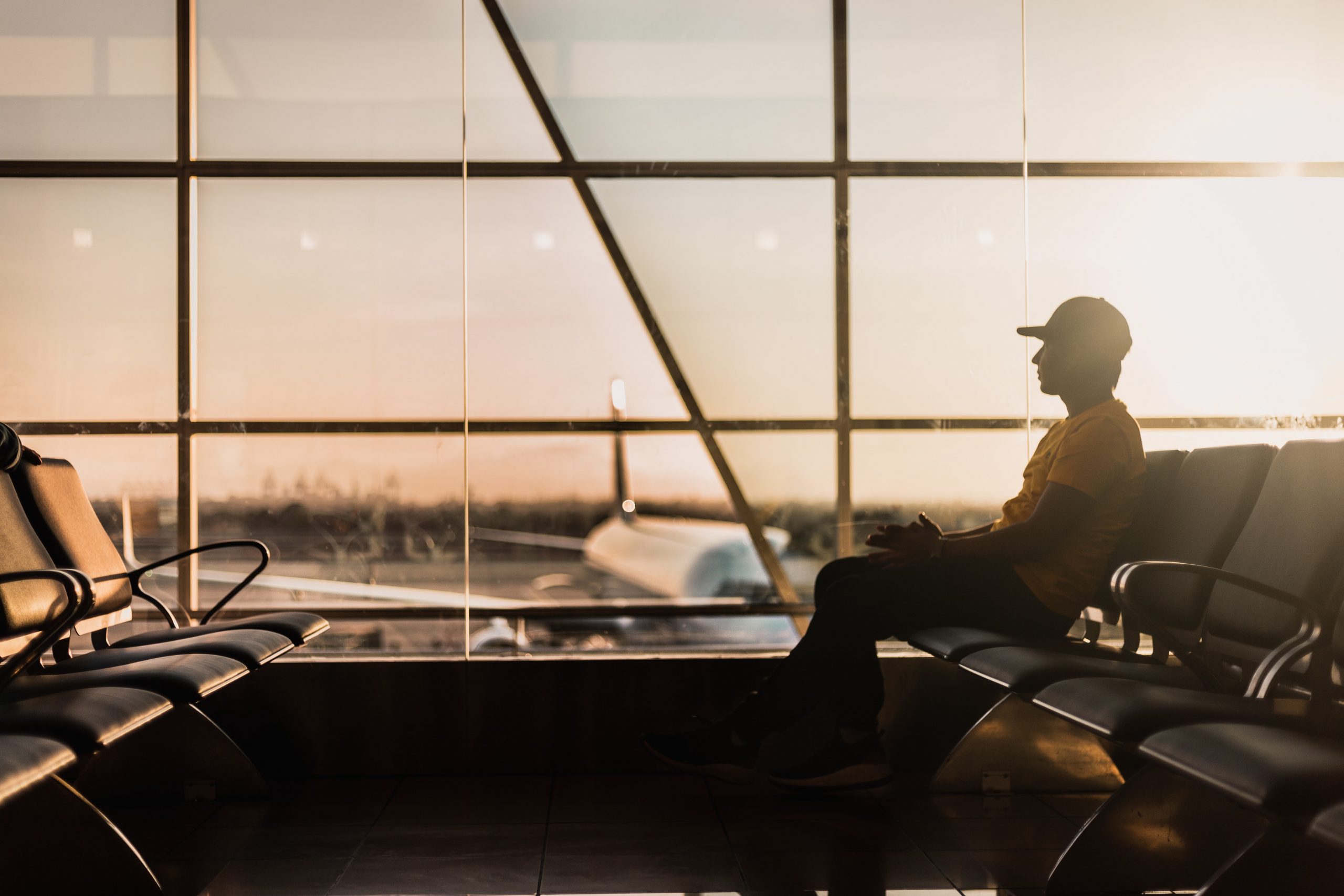 a man sitting on a chair at an airport