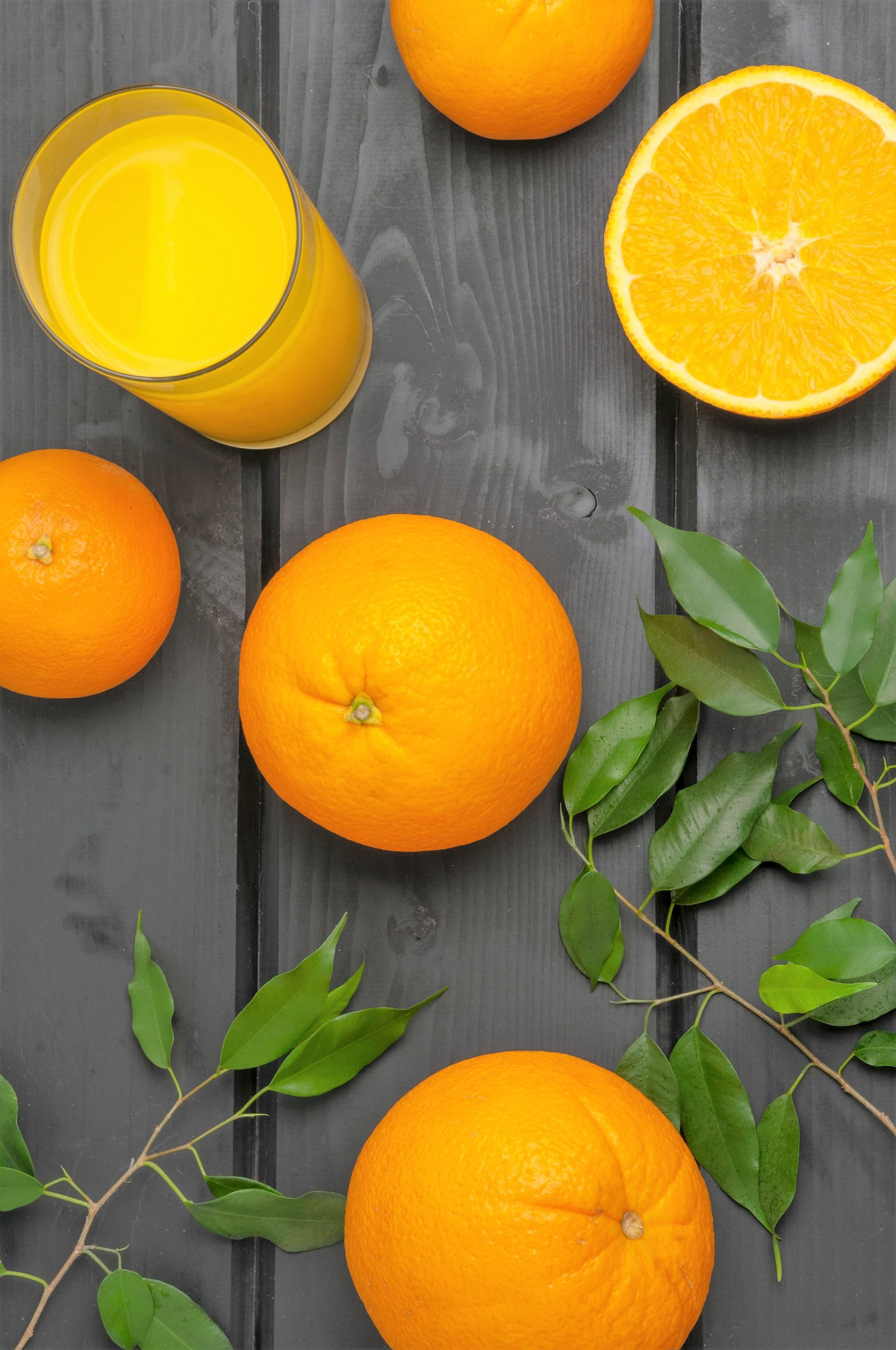 some oranges and a glass of juice