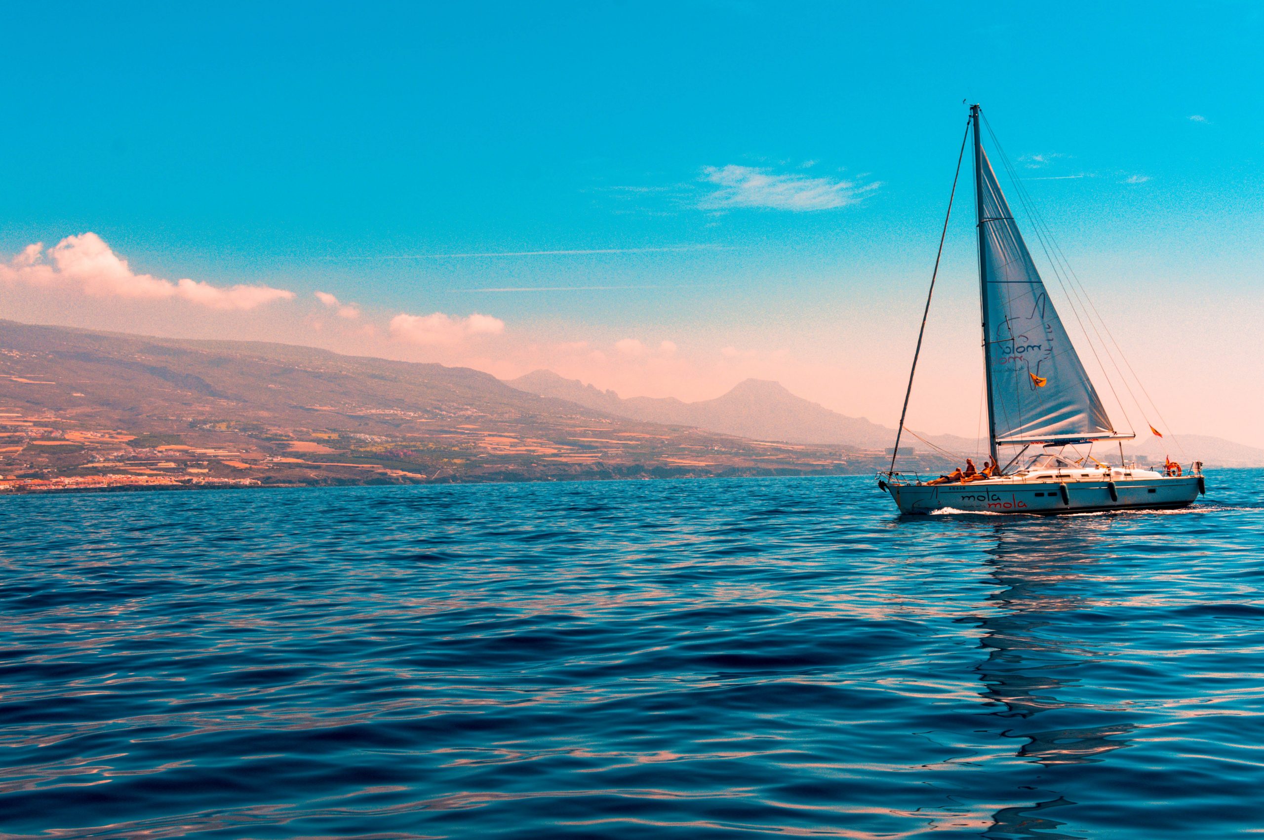 sailboat on water near island