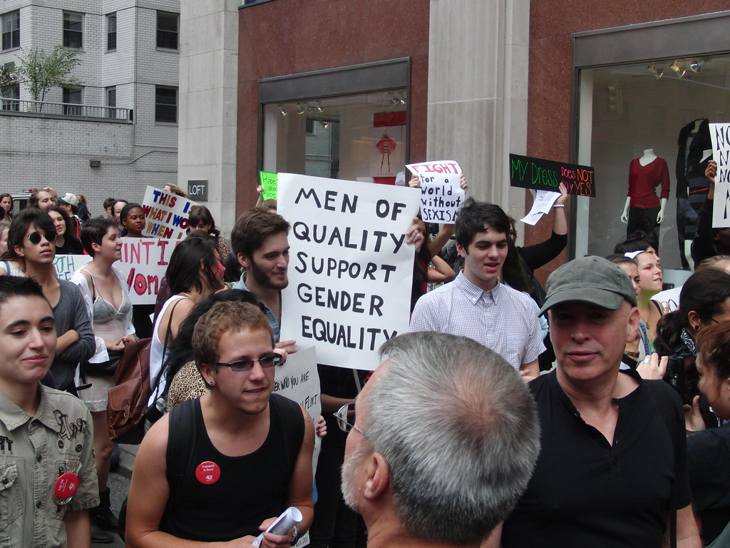 image from protest showing men marching for and supporting gender inequality