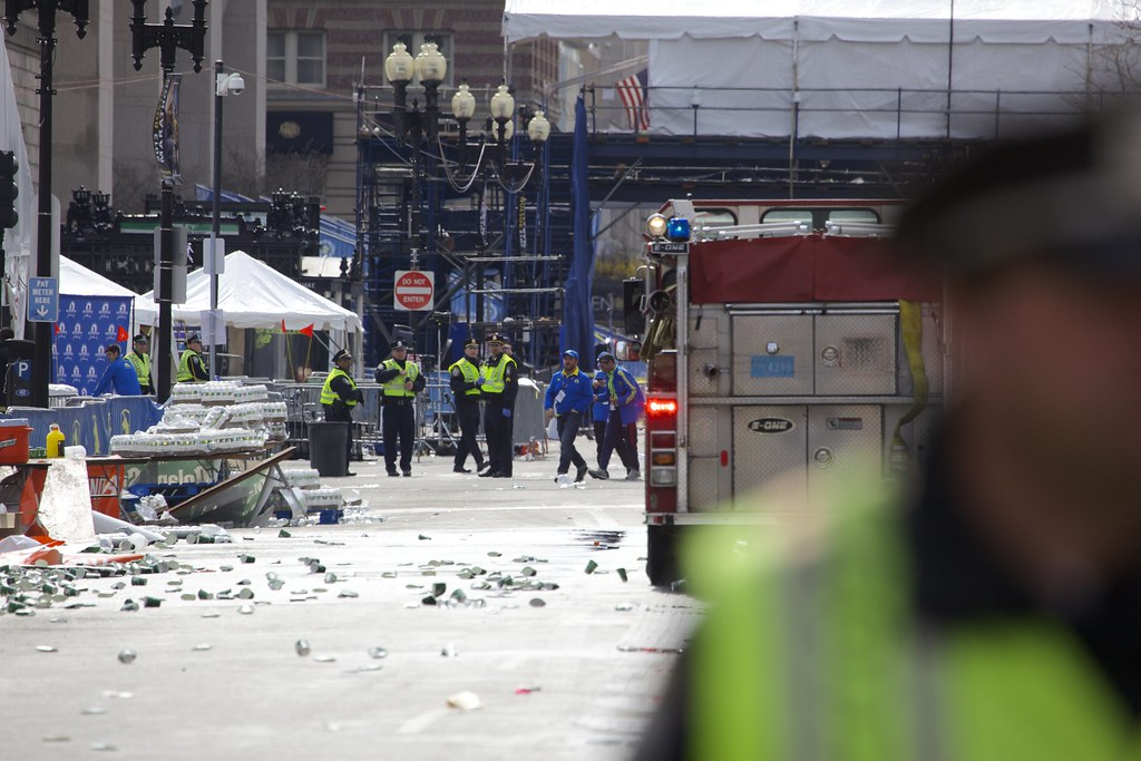 image of a street in Boston with police, fire trucks and rubble following the Boston Marathon bombing.