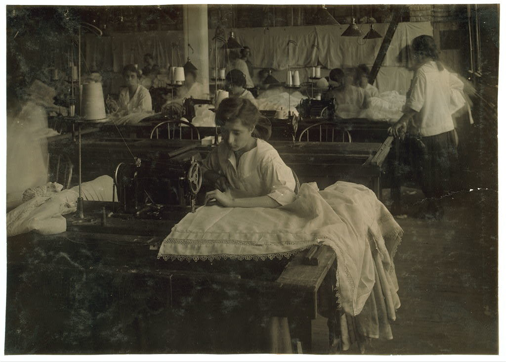 image of young teenage girls working full-time in a factory sewing curtains