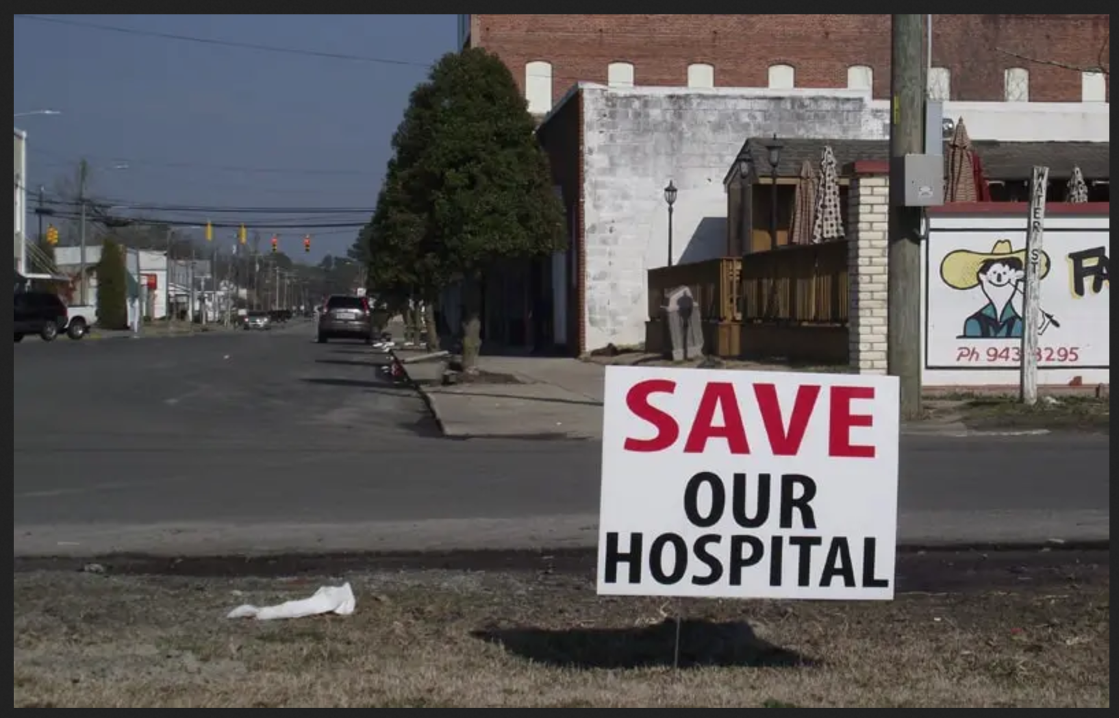 image of sign stating "save our hospital"