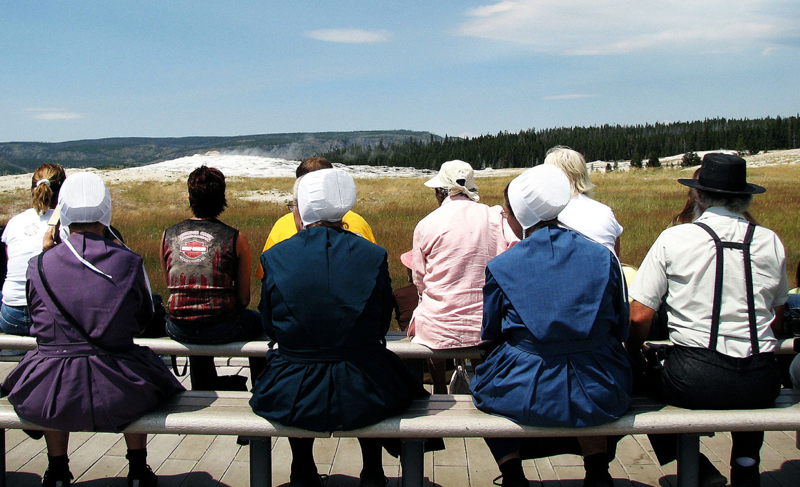 Photo of group of Amish visiting Yellowstone National Park waiting for the Old Faithful geyser to erupt.